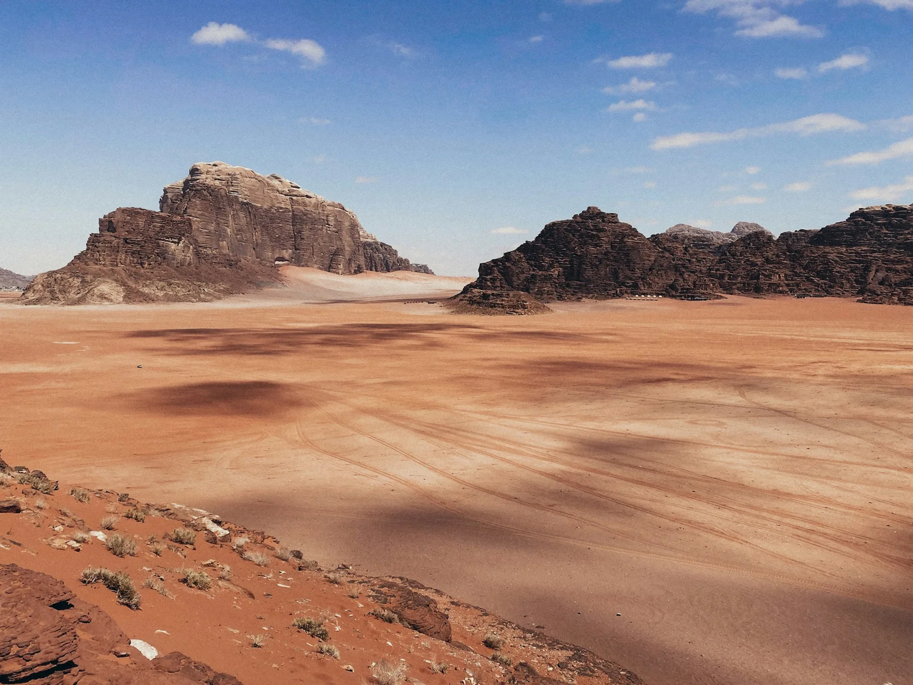 Sandstone outcrops and wide stretches of sand in Wadi Rum, Jordan